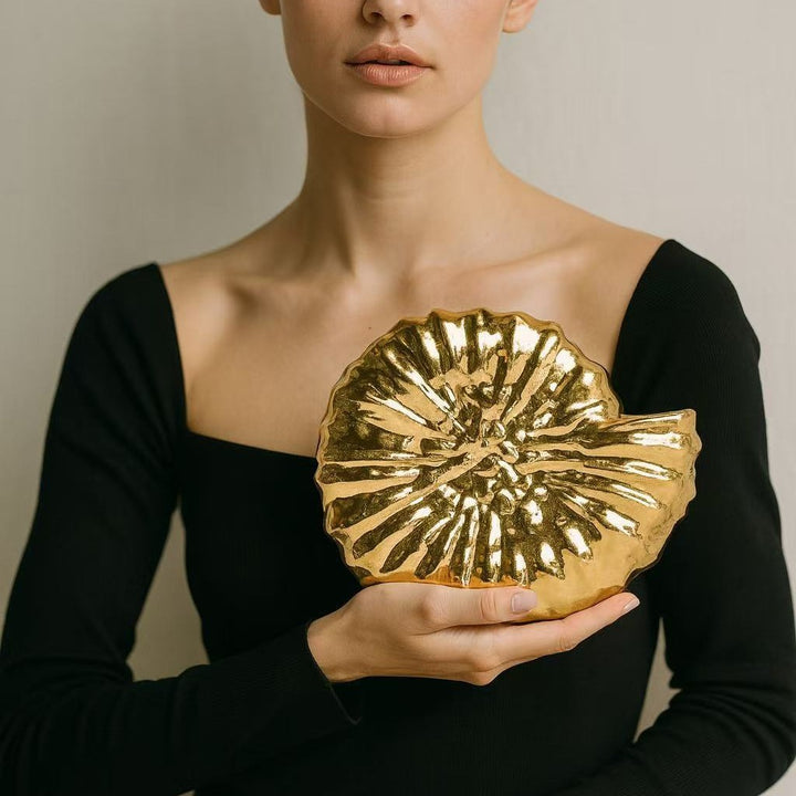 Round sculpted gold clutch with organic texture – BLOOM