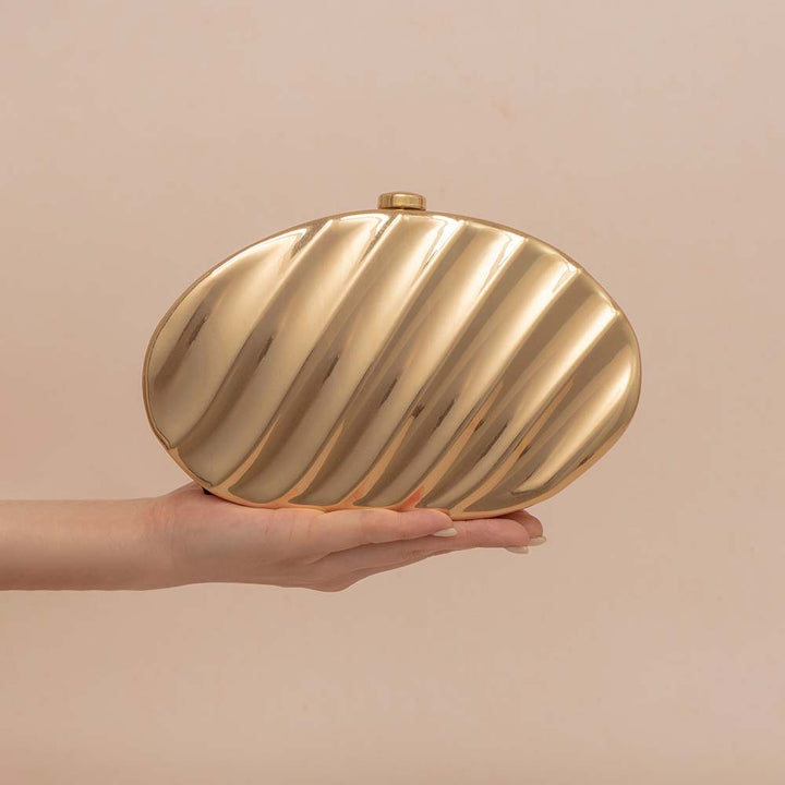 Textured metallic clutch with sculpted wave design – SHELL