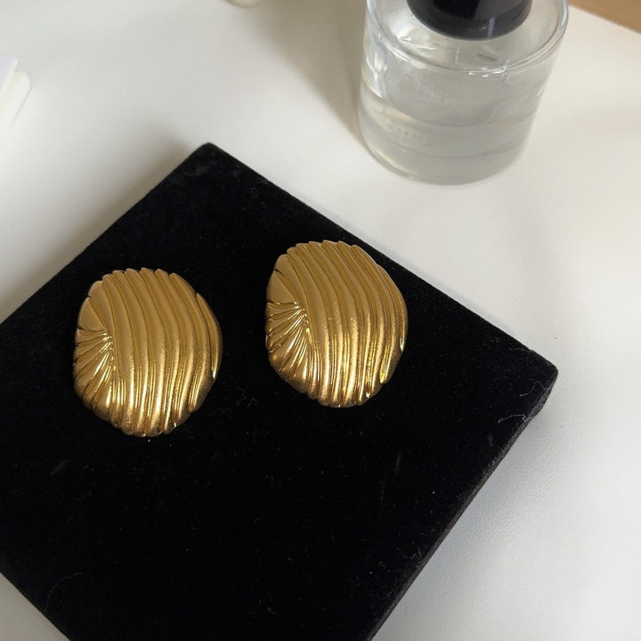 textured oval stud earrings with metallic finish - LYRANU